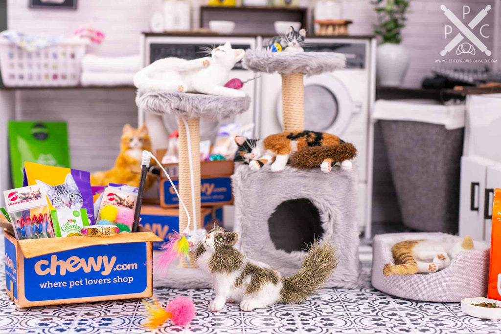 Dollhouse miniature cats and kittens with shipping boxes of toys and food from Chewy in a one inch scale scene by Erika Pitera, The Petite Provisions Co.