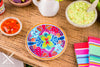 A beautiful and detailed miniature replica of a Mexican Talavera pottery plate. The plate is decorated with bright colors and intricate designs, and it is filled with realistic food items.