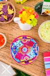 A beautiful and detailed miniature replica of a Mexican Talavera pottery plate. The plate is decorated with bright colors and intricate designs, and it is filled with realistic food items.