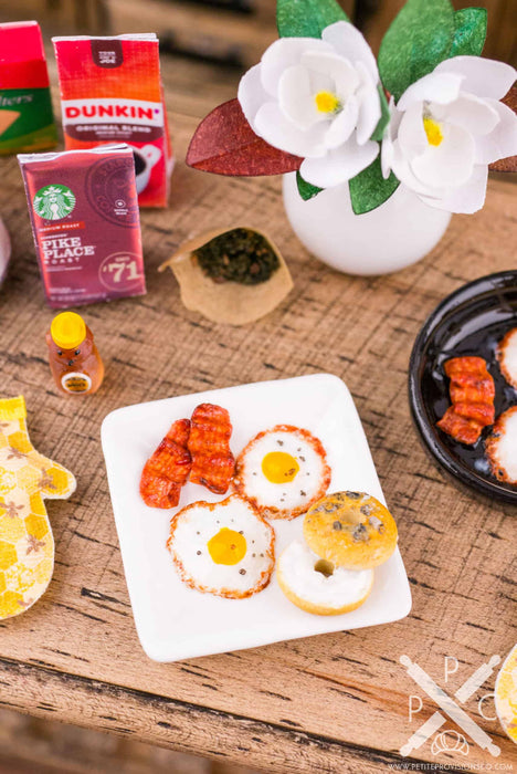 Plate of Fried Eggs, Bacon and Bagel with Cream Cheese