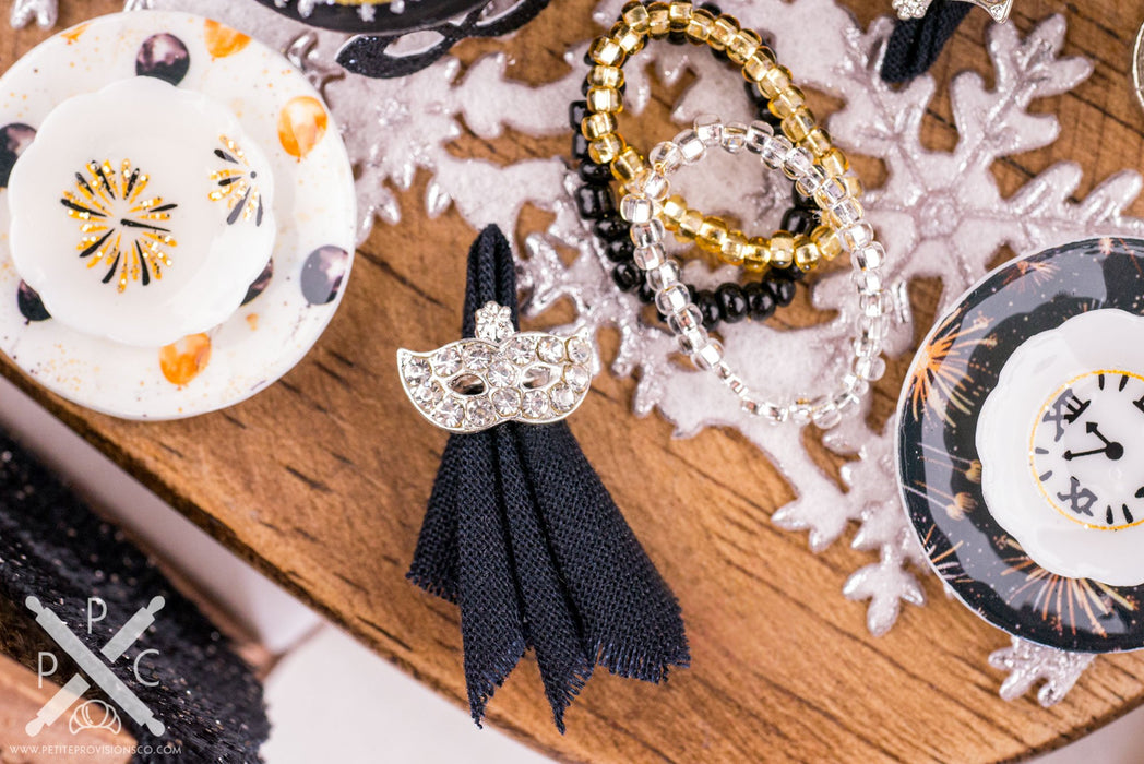 New Year's Mask Napkin Rings and Black Cloth Napkins