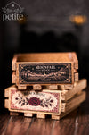 Stacked handcrafted miniature wine crates featuring Moonfall Estate moonlit vineyard and Black Rose Cellars botanical labels in a 1:12 scale Art Deco bar setting.